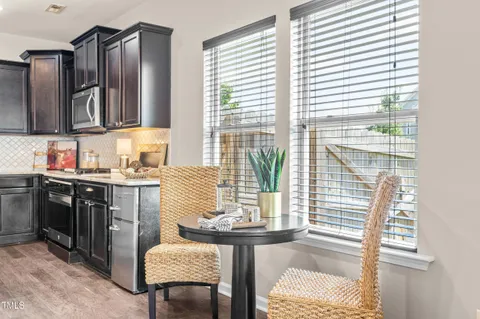 a kitchen with stainless steel appliances granite countertop sink microwave and refrigerator