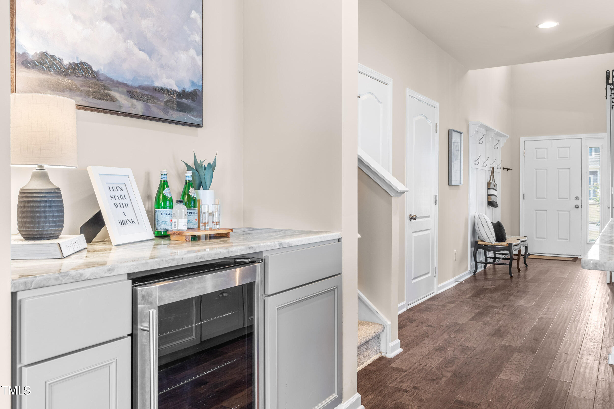1304 Ivey Grove Court Fuquay-Varina, NC 27526 - Photo 14 of 44 a kitchen with stainless steel appliances white cabinets and wooden floor