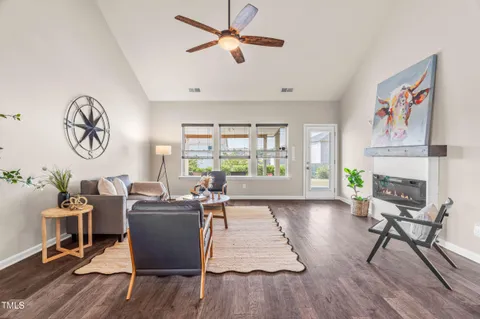 a living room with furniture a fireplace and a window