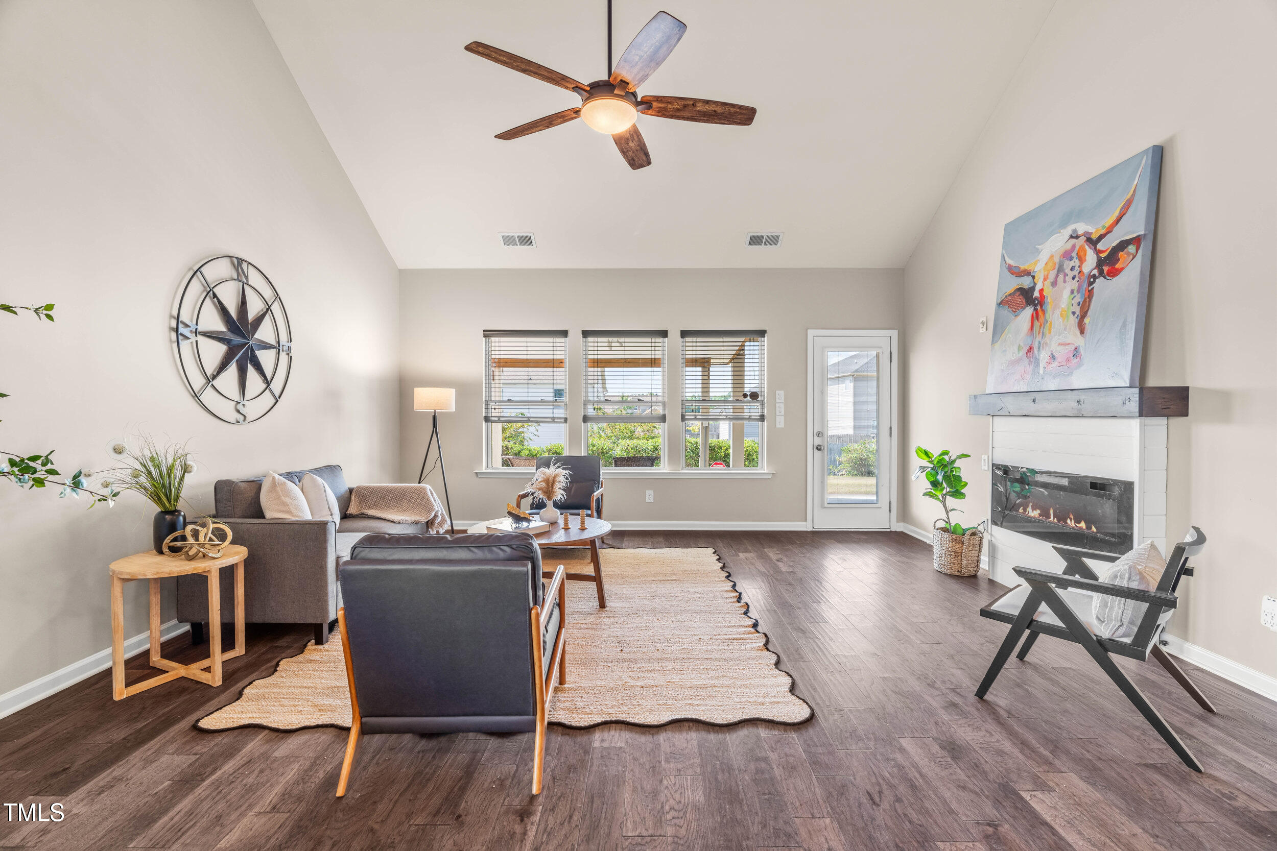 1304 Ivey Grove Court Fuquay-Varina, NC 27526 - Photo 15 of 44 a living room with furniture a fireplace and a window