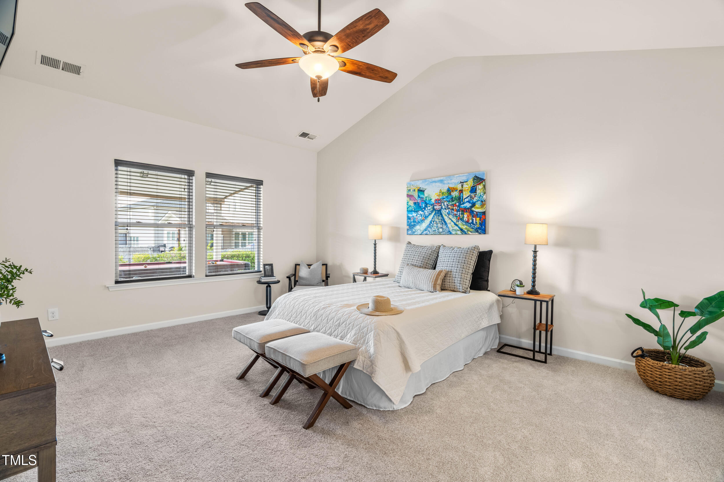 1304 Ivey Grove Court Fuquay-Varina, NC 27526 - Photo 20 of 44 a spacious bedroom with a bed and a chandelier