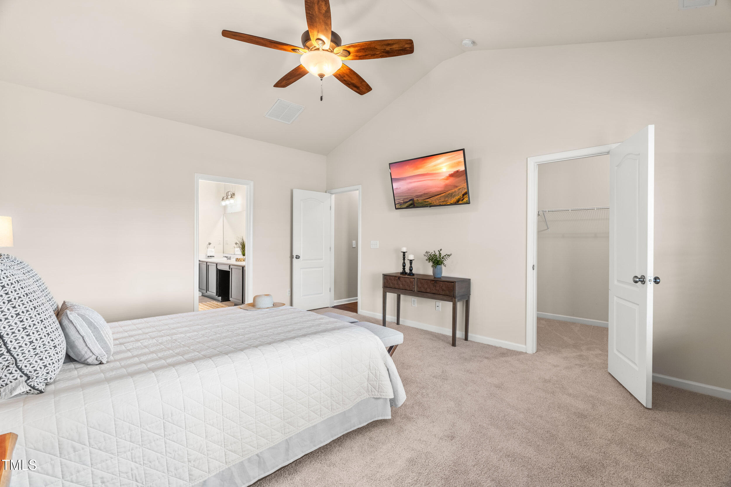 1304 Ivey Grove Court Fuquay-Varina, NC 27526 - Photo 21 of 44 a bedroom with a bed and a flat screen tv