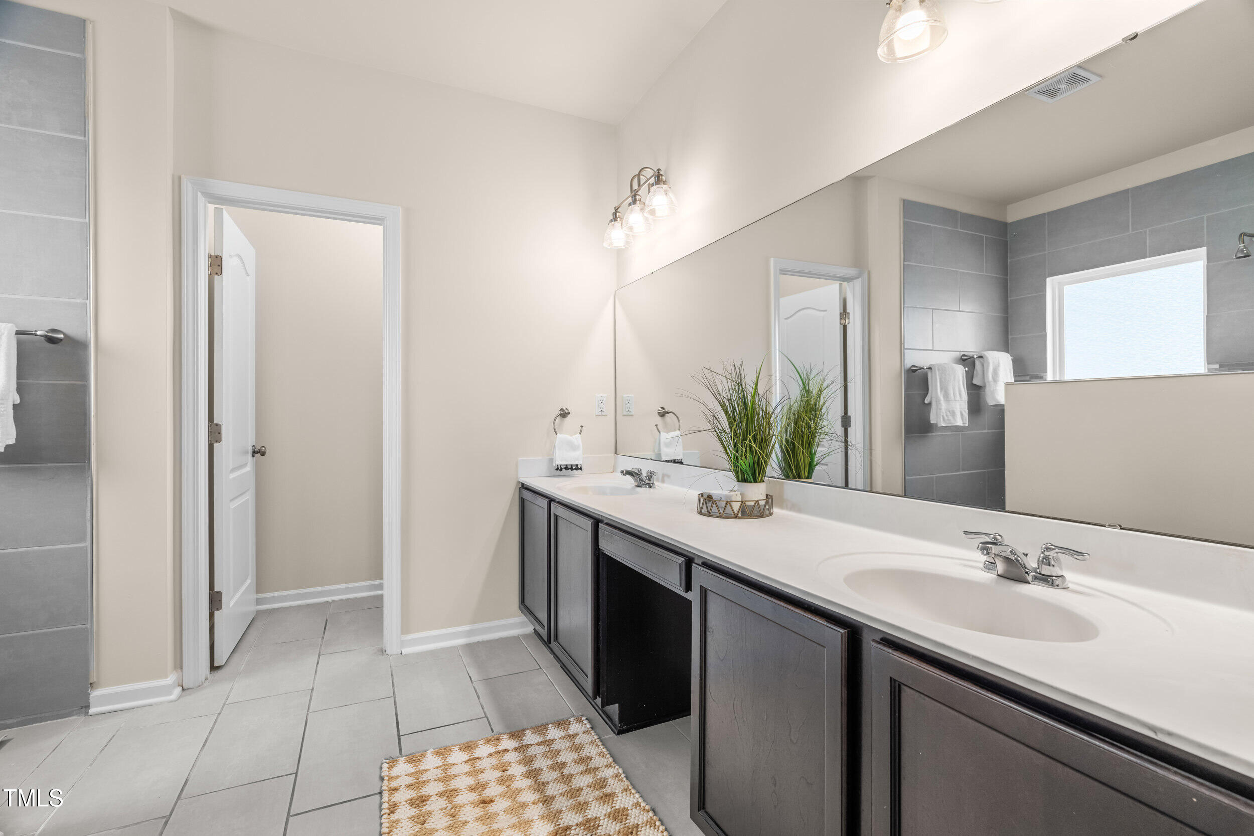 1304 Ivey Grove Court Fuquay-Varina, NC 27526 - Photo 22 of 44 a bathroom with a sink and a mirror