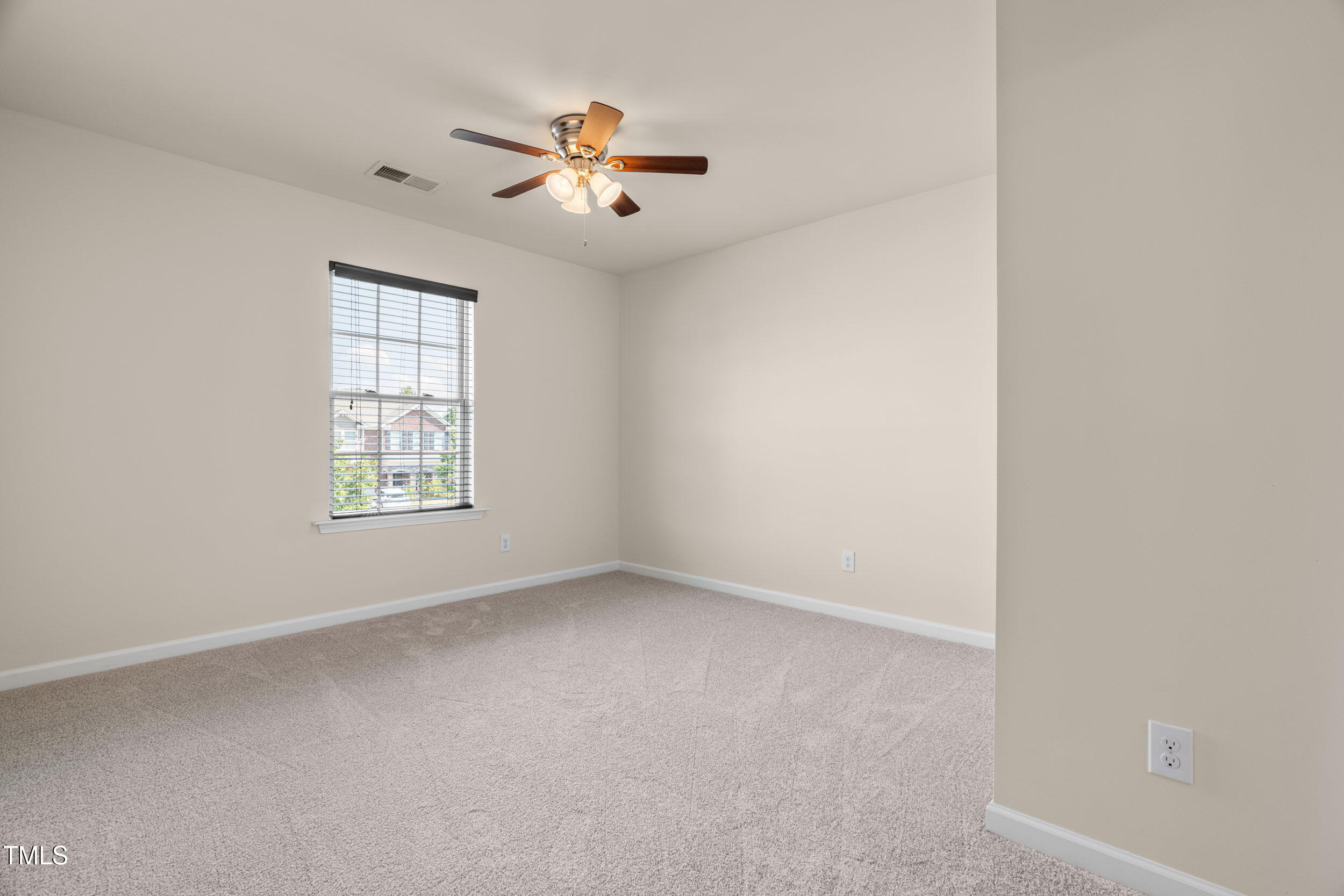 1304 Ivey Grove Court Fuquay-Varina, NC 27526 - Photo 27 of 44 an empty room with windows and fan