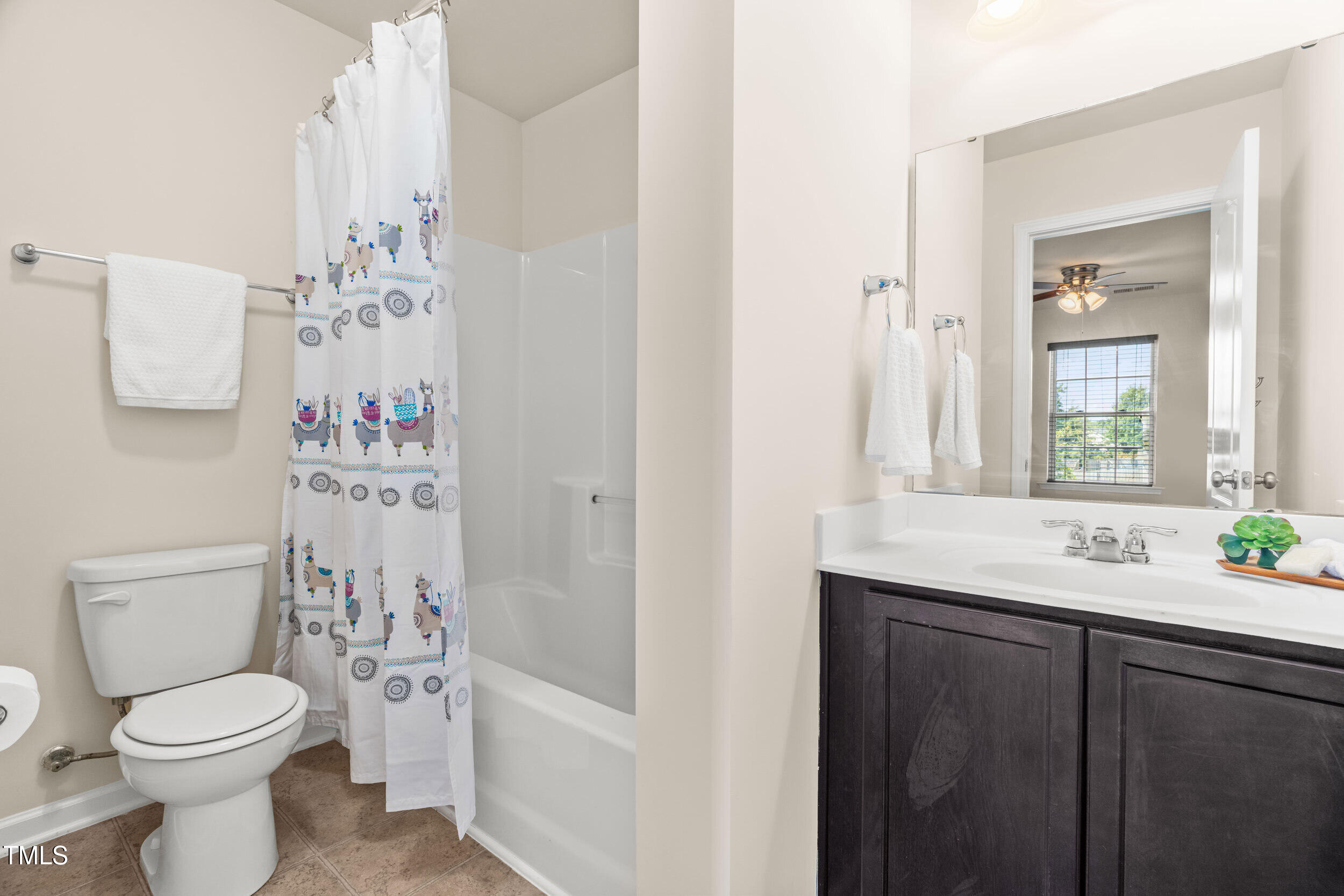 1304 Ivey Grove Court Fuquay-Varina, NC 27526 - Photo 29 of 44 a bathroom with a sink a toilet and shower curtain