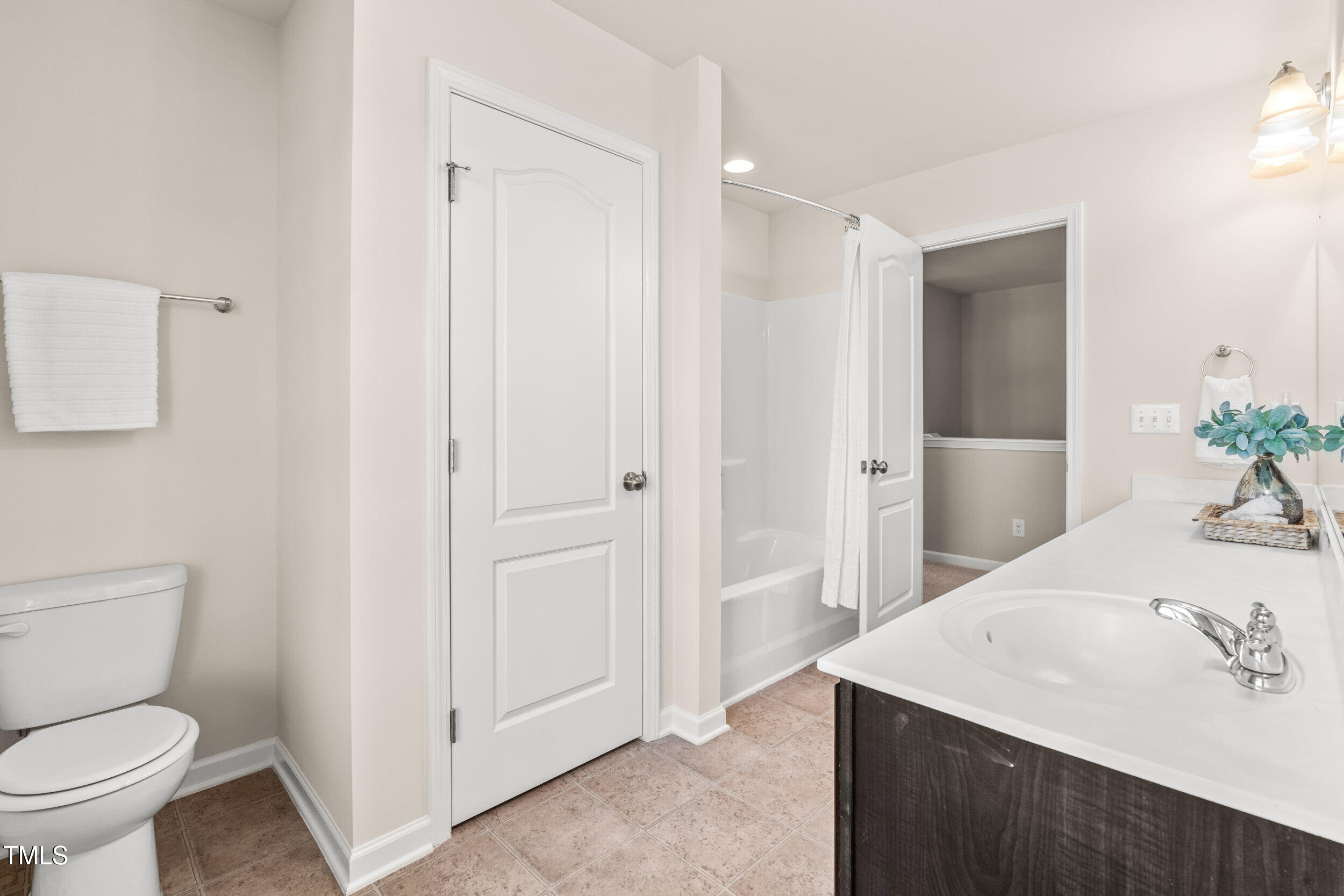 1304 Ivey Grove Court Fuquay-Varina, NC 27526 - Photo 31 of 44 a bathroom with a sink a toilet and shower