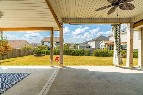 a view of swimming pool with lawn chairs under an umbrella