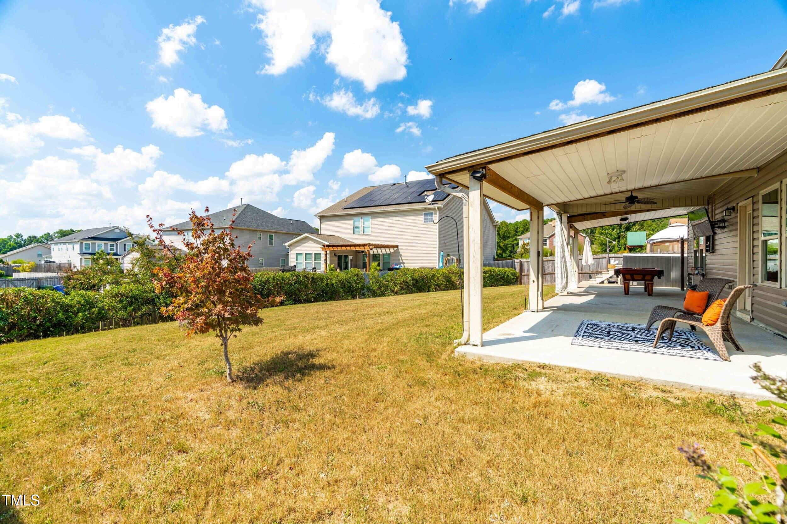 1304 Ivey Grove Court Fuquay-Varina, NC 27526 - Photo 35 of 44 a view of a patio with a table and chairs and potted plants