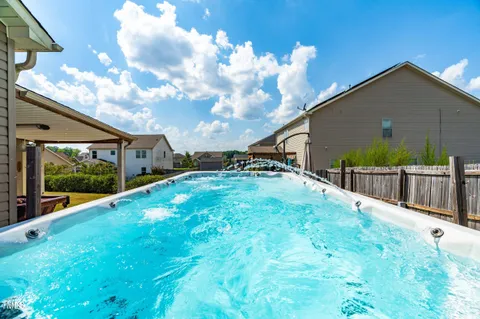 a view of backyard with garden and deck