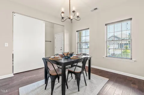 a view of a dining room with furniture and window