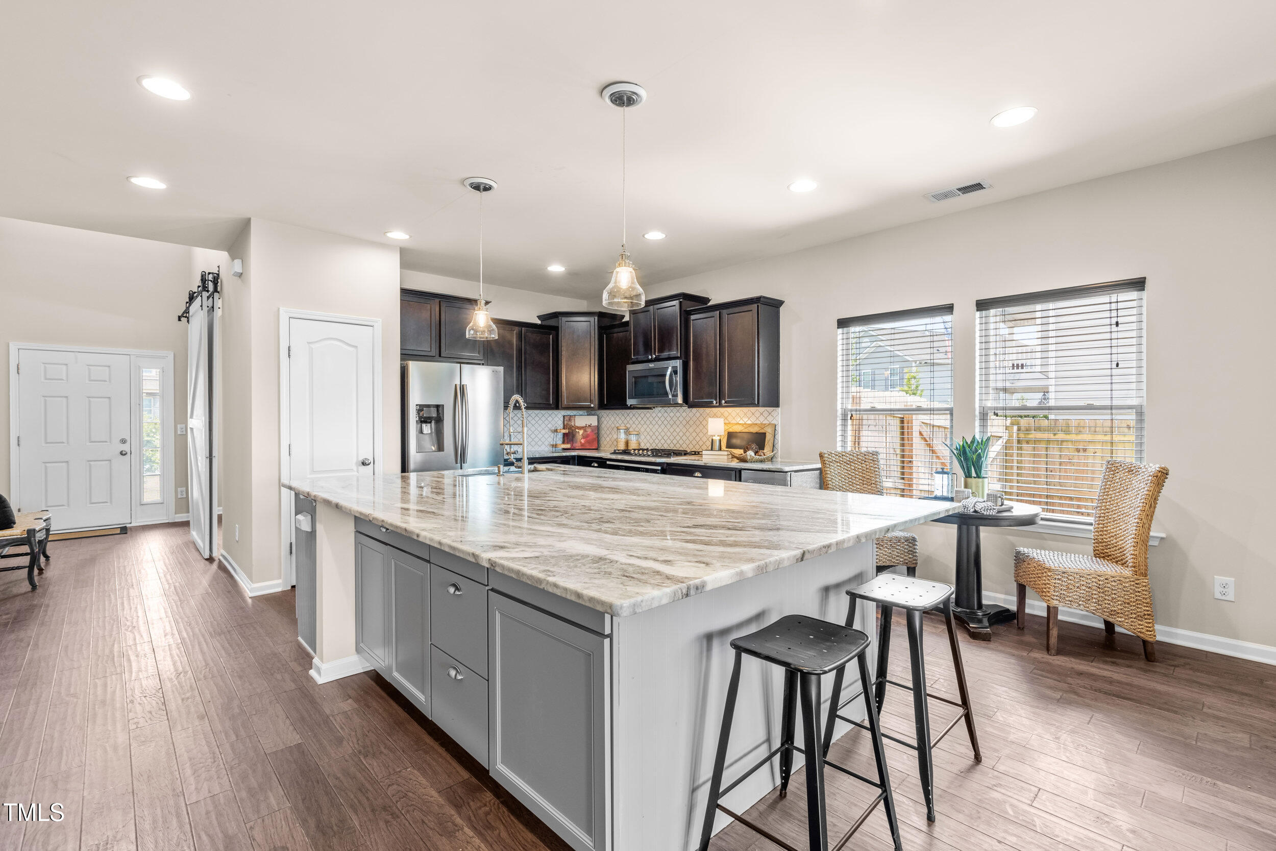 1304 Ivey Grove Court Fuquay-Varina, NC 27526 - Photo 9 of 44 a large kitchen with stainless steel appliances a large island in the center