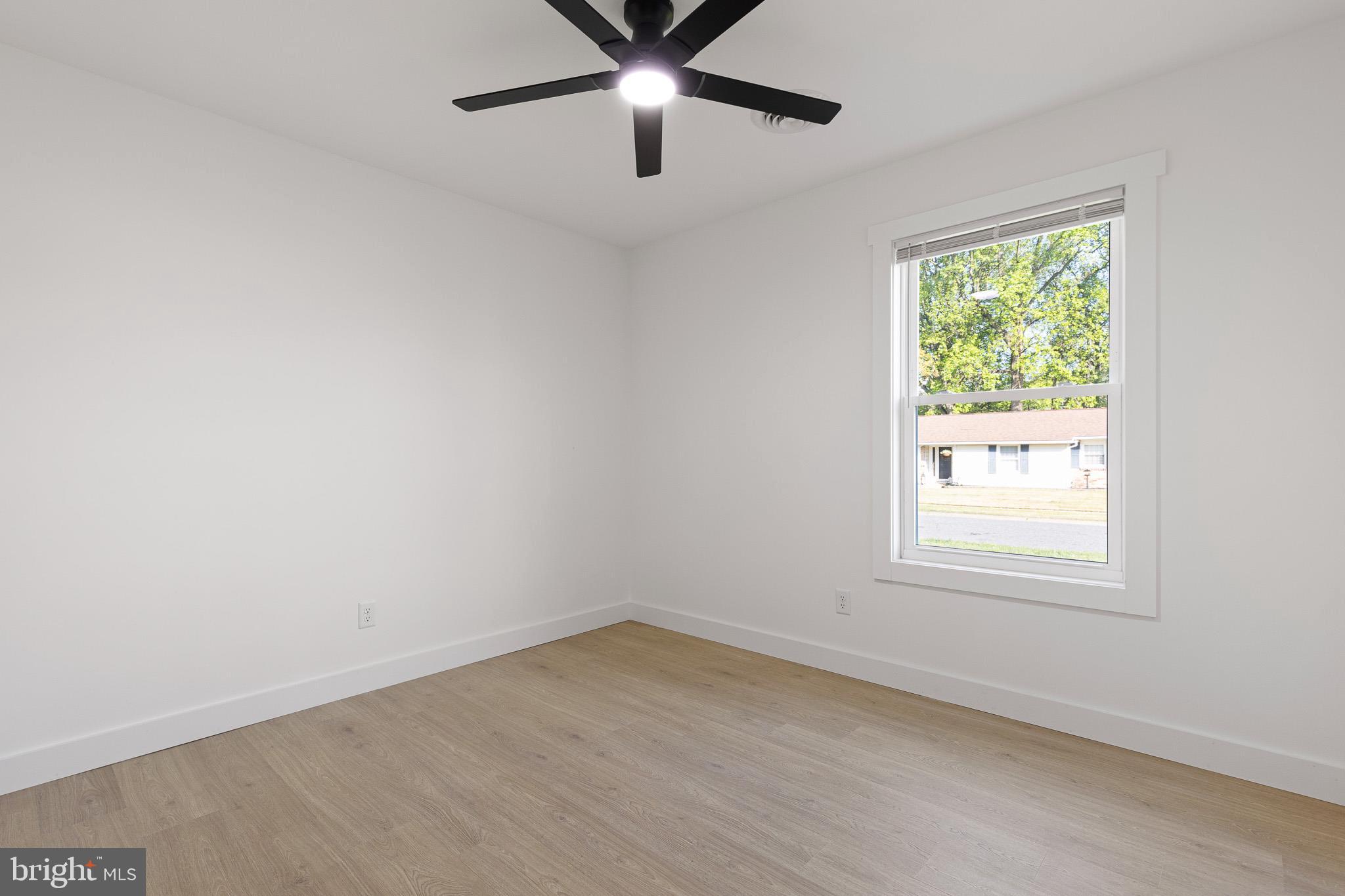 3 Queens Way Newark, DE 19713 - Photo 14 of 20 an empty room with a window and a ceiling fan