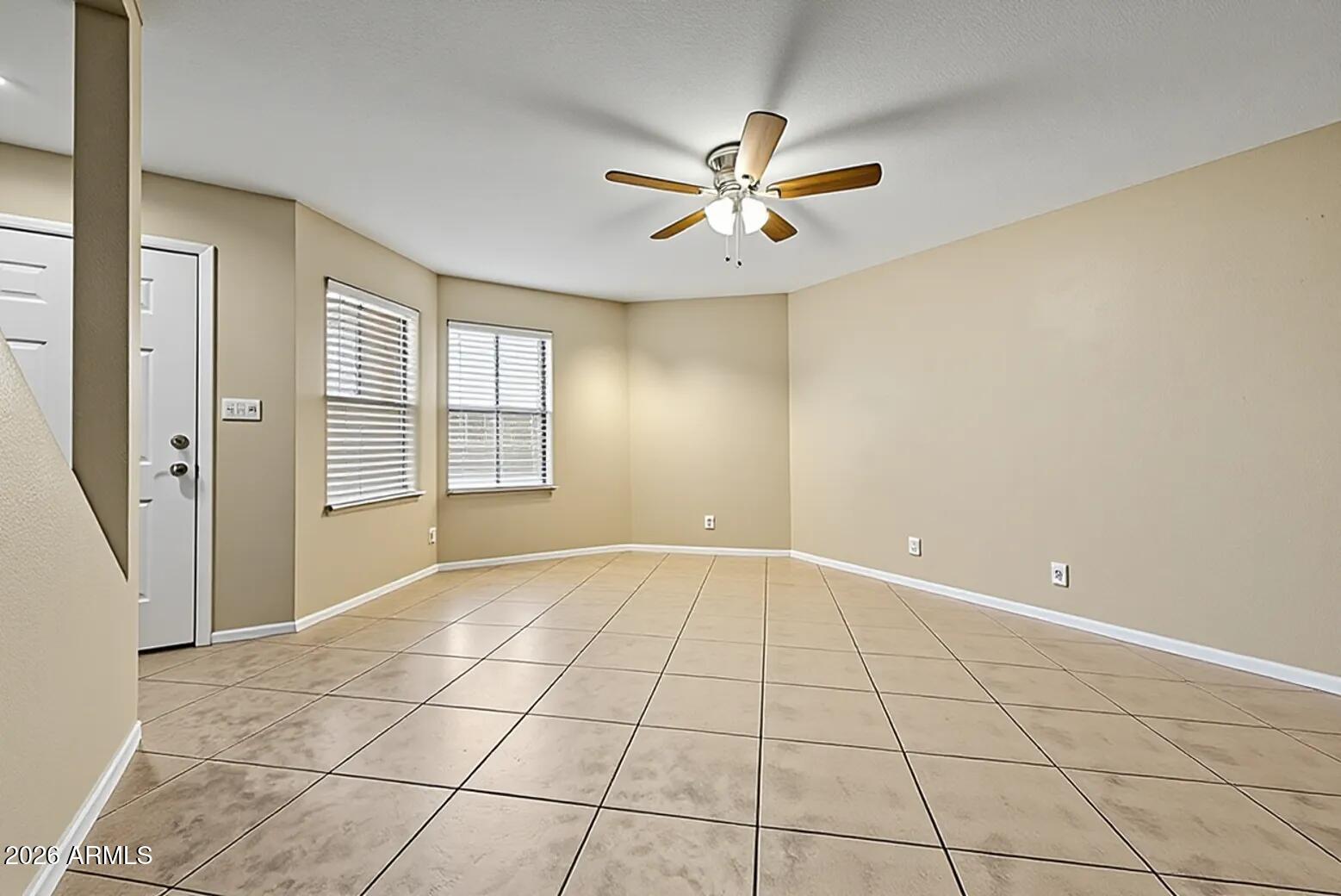 6262 East Brown Road, Unit 29 Mesa, AZ 85205 - Photo 14 of 59 a view of an empty room with window and chandelier fan