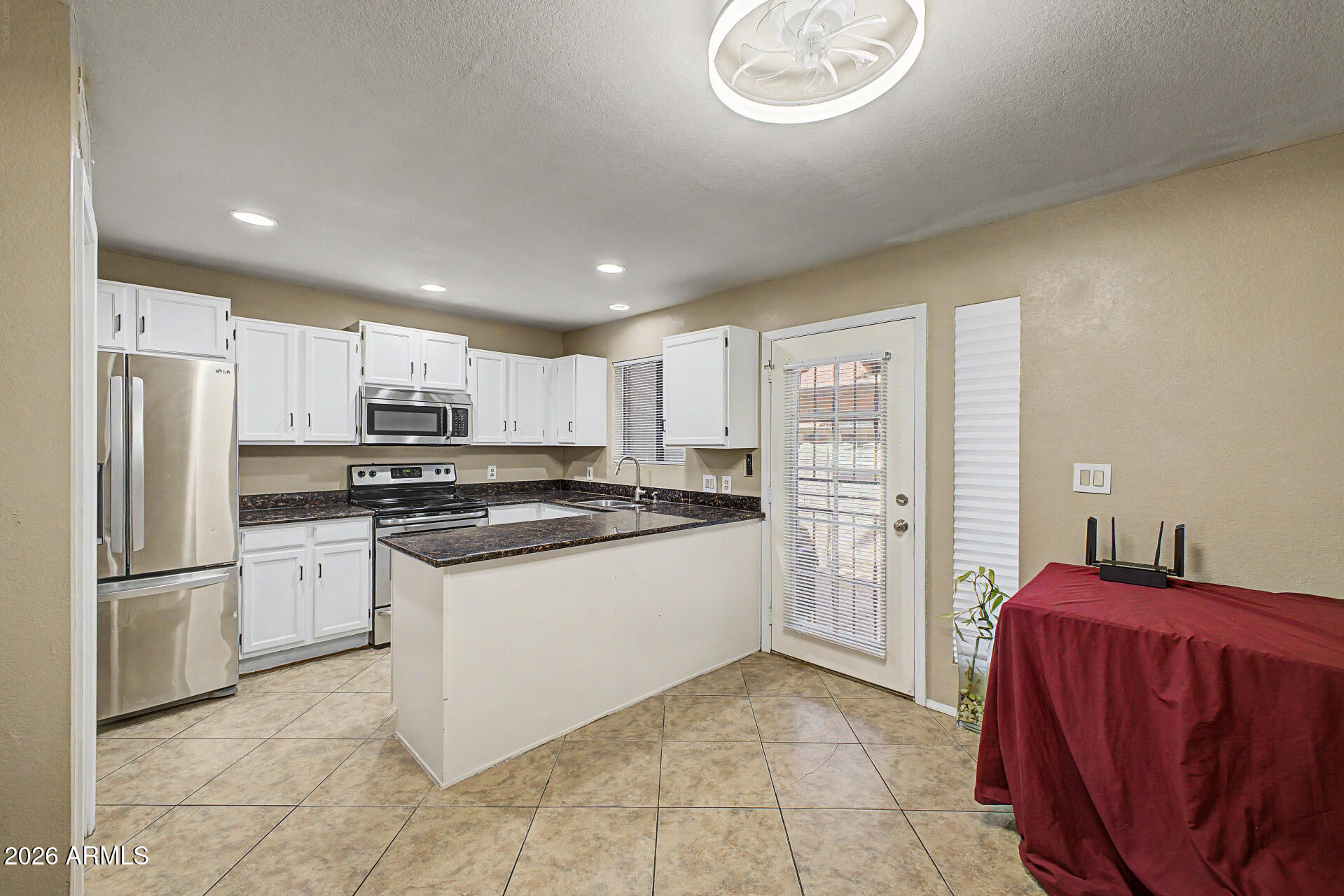 6262 East Brown Road, Unit 29 Mesa, AZ 85205 - Photo 16 of 59 a kitchen with stainless steel appliances granite countertop a refrigerator sink and stove