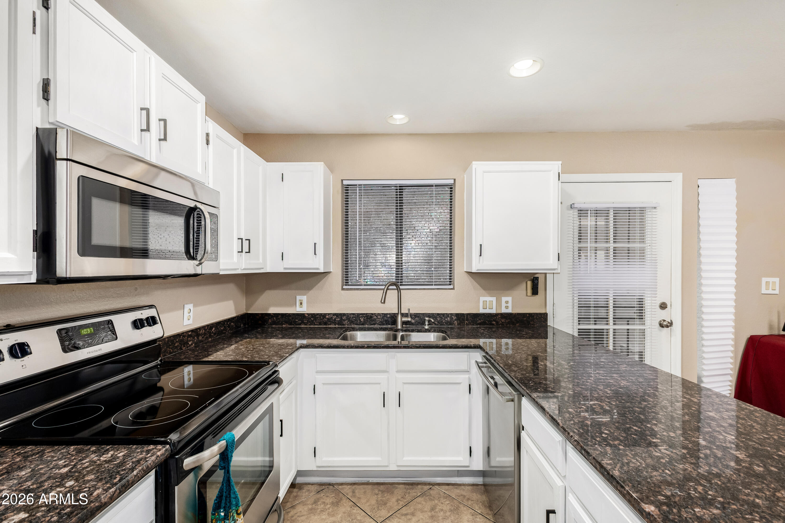 6262 East Brown Road, Unit 29 Mesa, AZ 85205 - Photo 18 of 59 a kitchen with a sink stove and microwave
