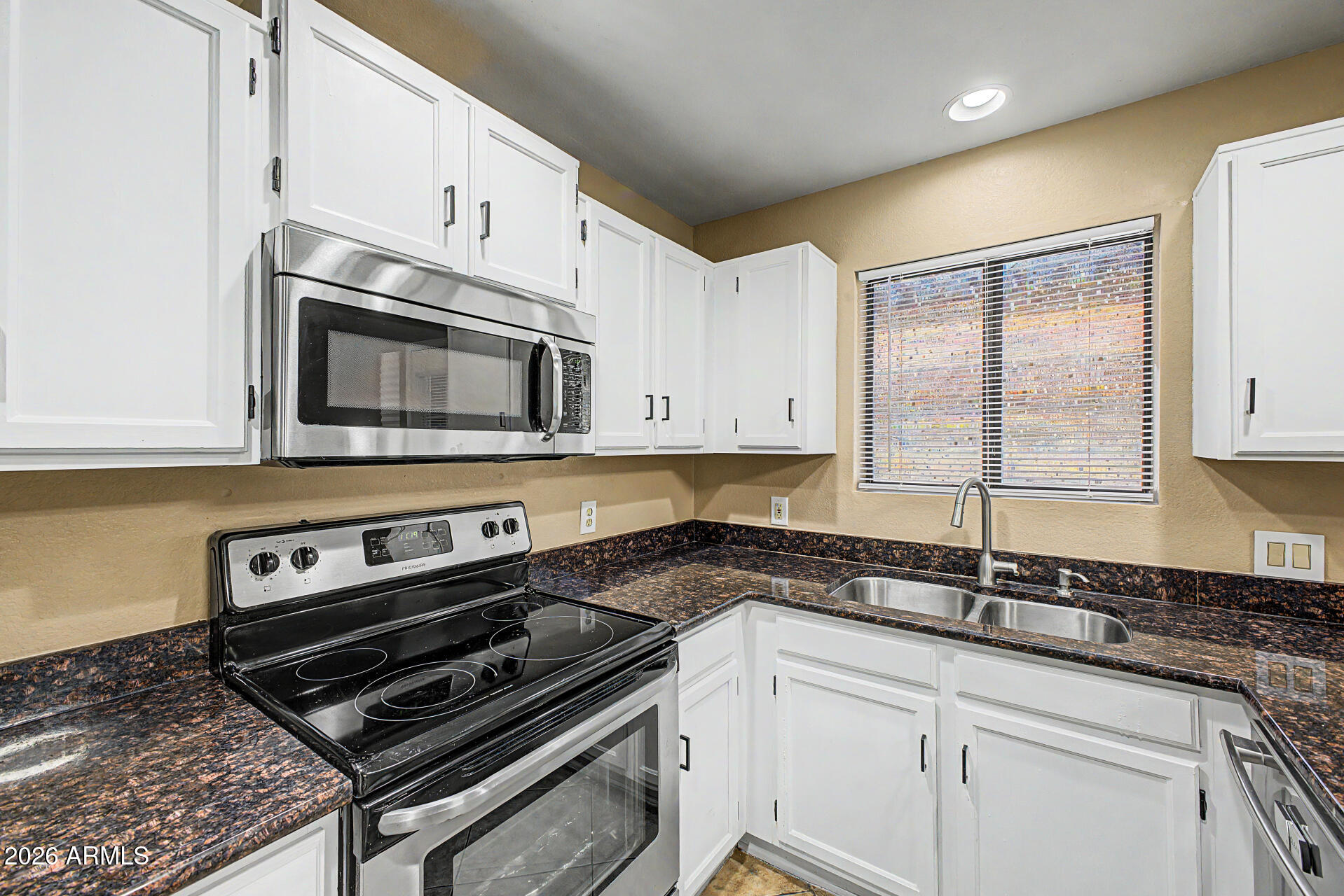 6262 East Brown Road, Unit 29 Mesa, AZ 85205 - Photo 19 of 59 a kitchen with granite countertop a sink cabinets and stainless steel appliances