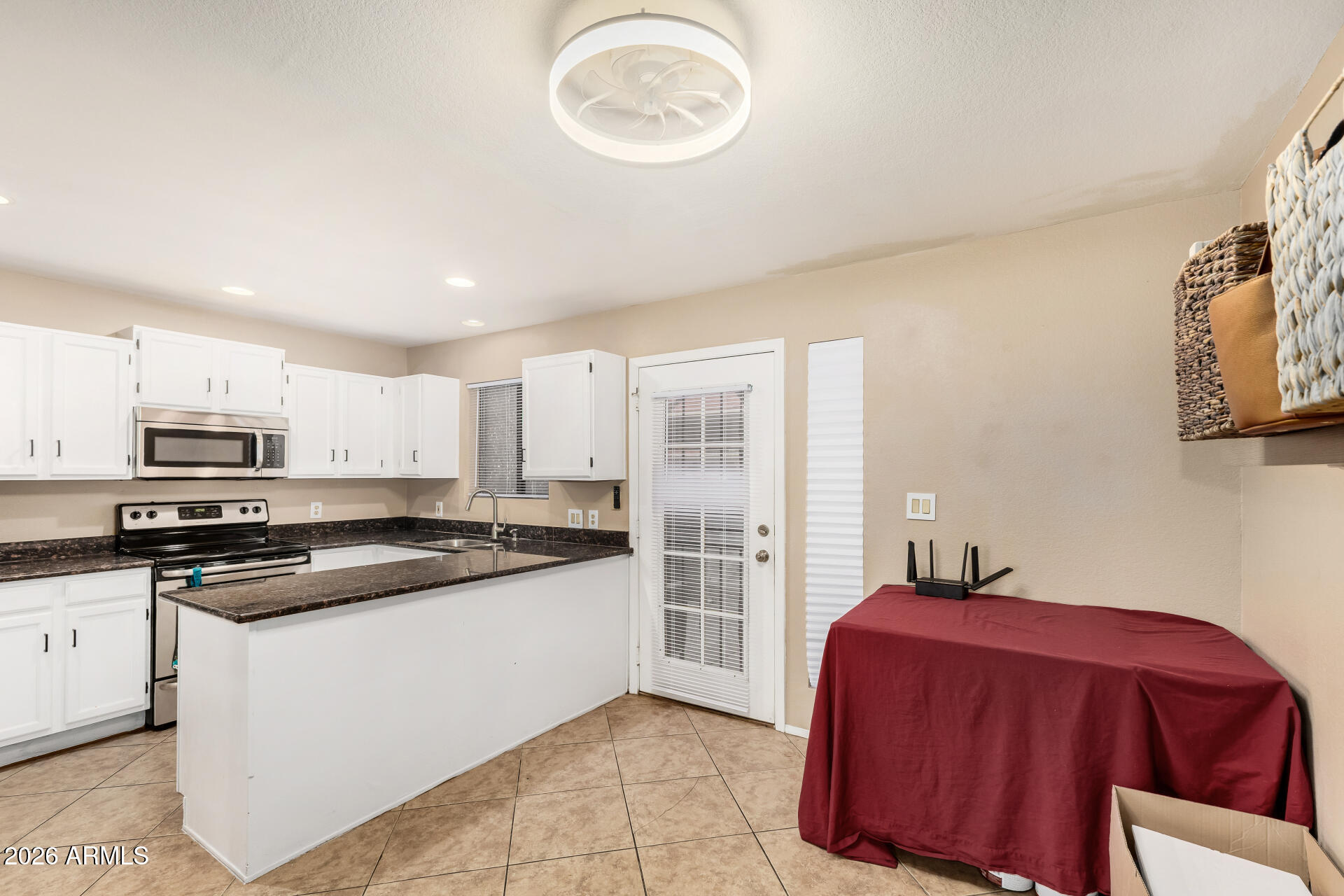 6262 East Brown Road, Unit 29 Mesa, AZ 85205 - Photo 24 of 59 a kitchen with stainless steel appliances granite countertop a stove a sink and a refrigerator