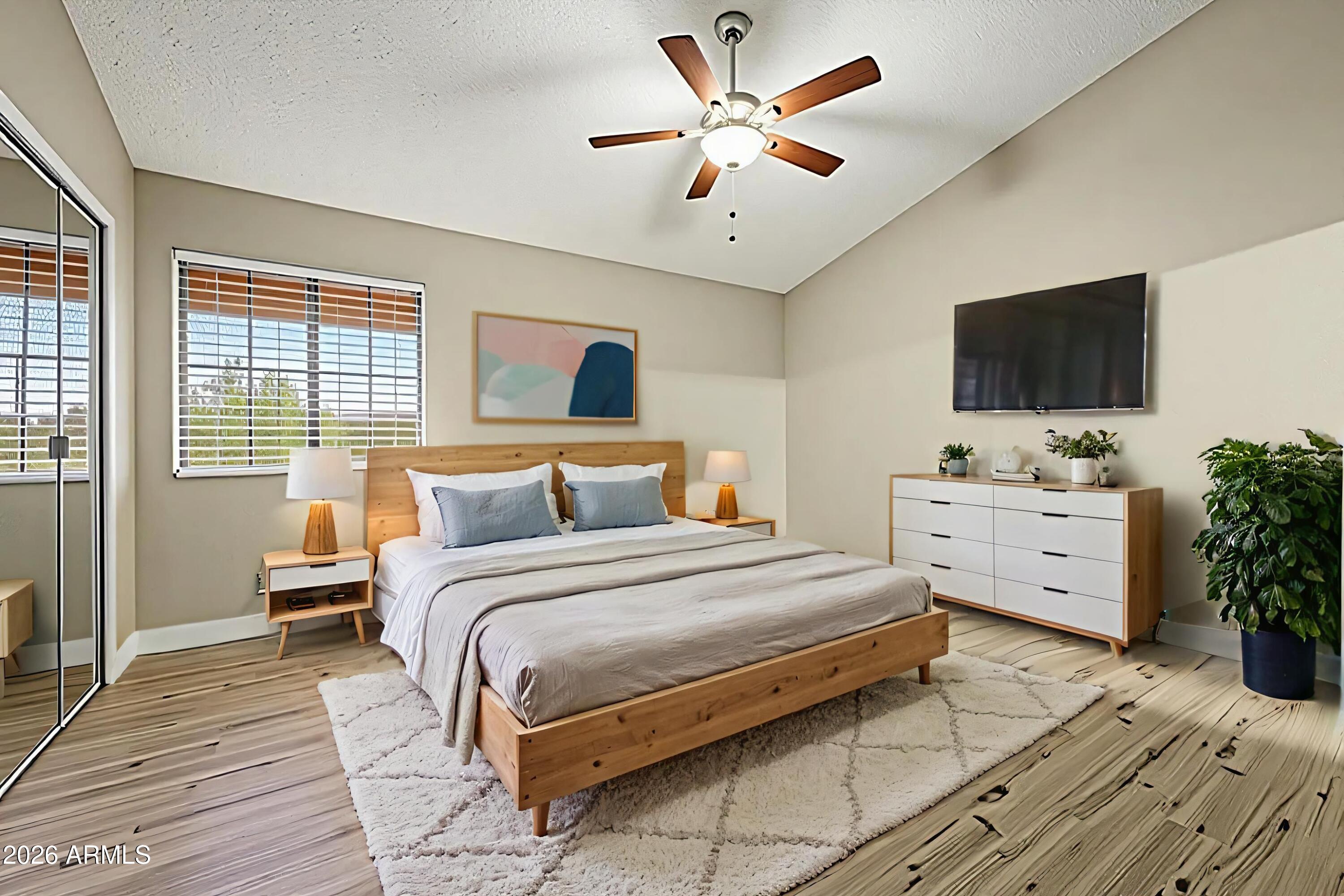 6262 East Brown Road, Unit 29 Mesa, AZ 85205 - Photo 36 of 59 a bedroom with a large bed and a flat screen tv