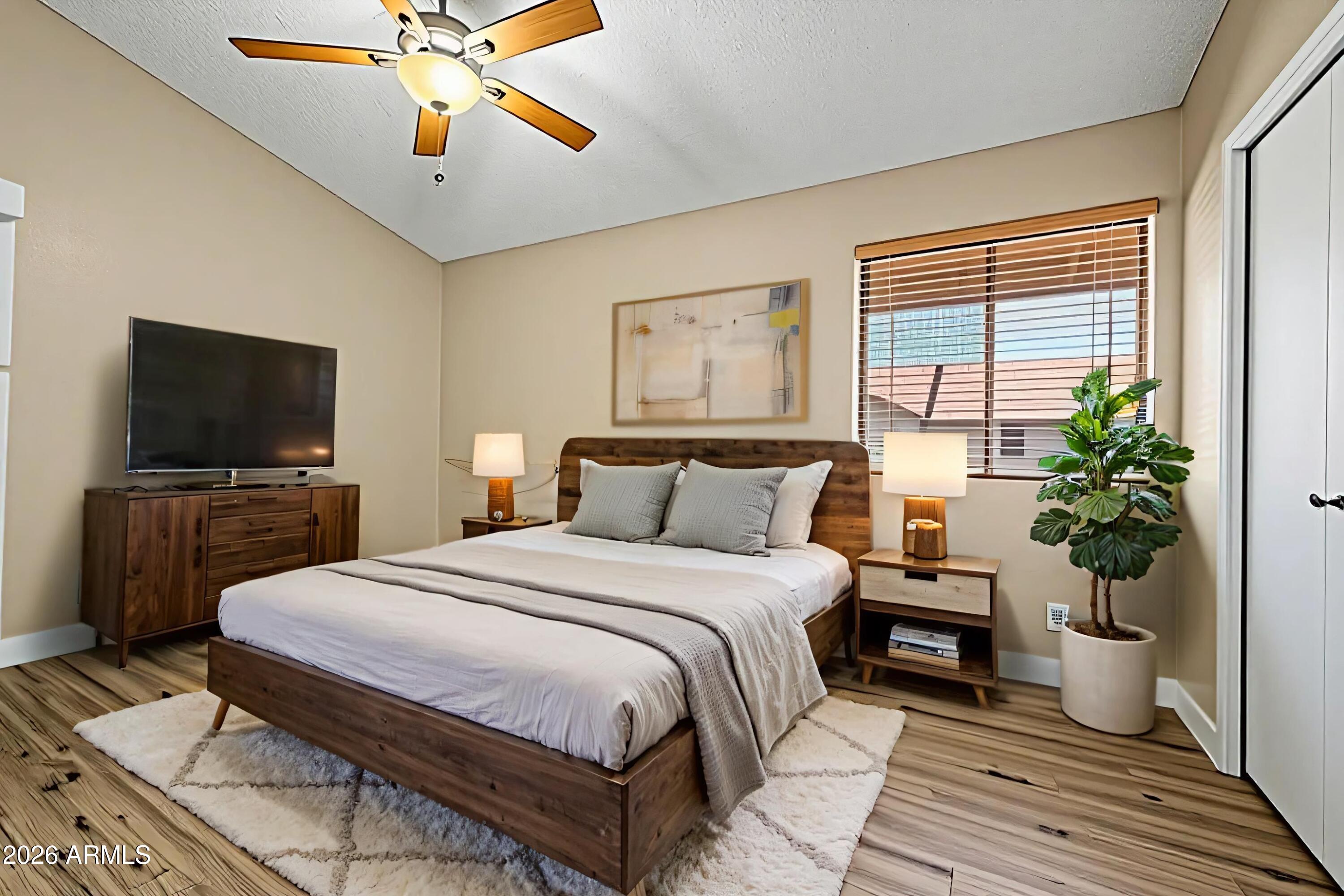 6262 East Brown Road, Unit 29 Mesa, AZ 85205 - Photo 38 of 59 a bedroom with a bed and a flat screen tv