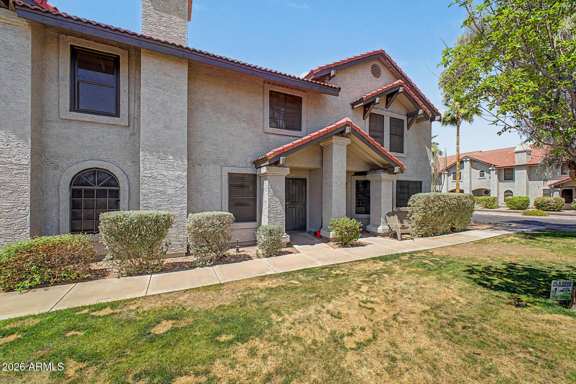 6262 East Brown Road, Unit 29 Mesa, AZ 85205 - Photo 51 of 59 a front view of a house with a yard
