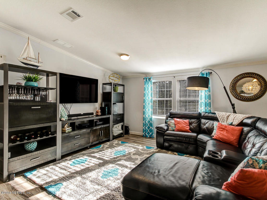 2244 Marlee Road South St. Johns, FL 32259 - Photo 11 of 38 a living room with furniture and a flat screen tv