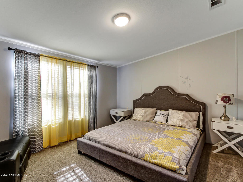 2244 Marlee Road South St. Johns, FL 32259 - Photo 14 of 38 a bedroom with a bed and a window