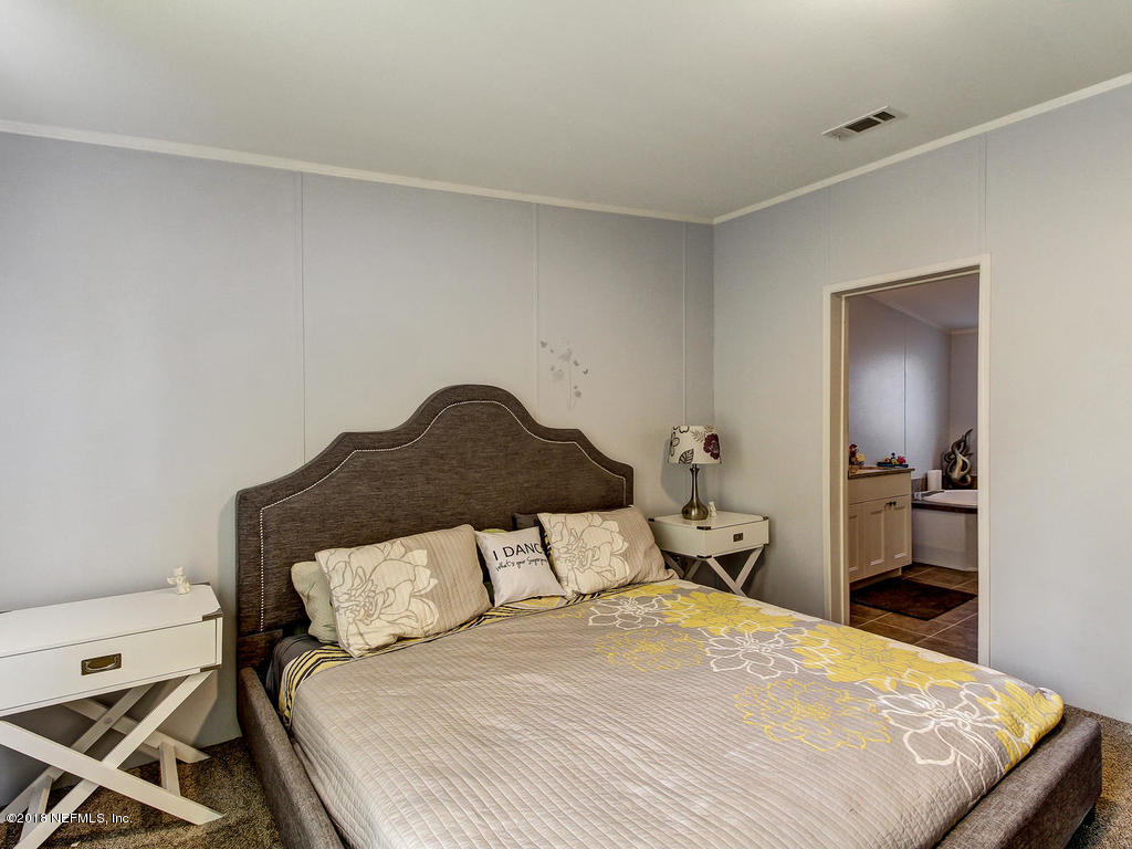 2244 Marlee Road South St. Johns, FL 32259 - Photo 15 of 38 a bedroom with a bed and a potted plant