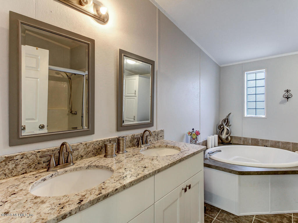 2244 Marlee Road South St. Johns, FL 32259 - Photo 18 of 38 a bathroom with a granite countertop sink and a mirror