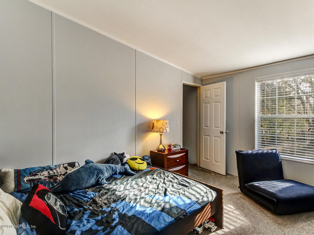 2244 Marlee Road South St. Johns, FL 32259 - Photo 20 of 38 a bedroom with a bed and a window