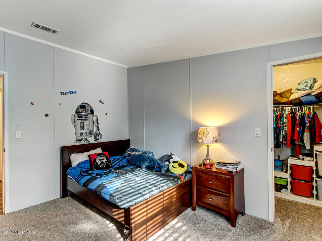 2244 Marlee Road South St. Johns, FL 32259 - Photo 21 of 38 a bed room with furniture and a window