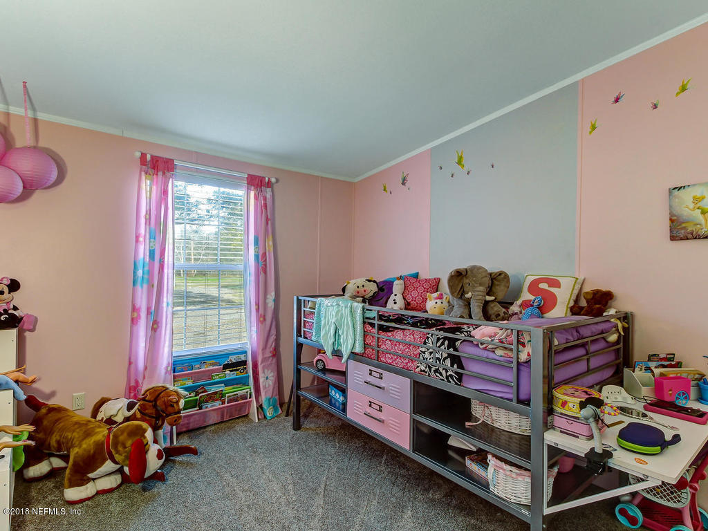 2244 Marlee Road South St. Johns, FL 32259 - Photo 22 of 38 a bed room with furniture and a window