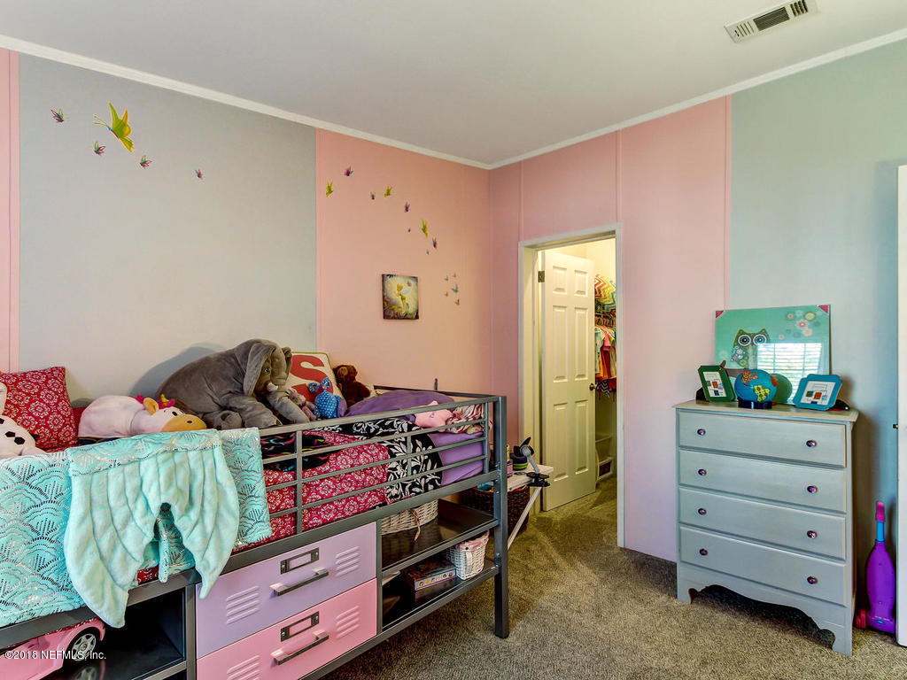 2244 Marlee Road South St. Johns, FL 32259 - Photo 23 of 38 a bed room with a bed and a dresser