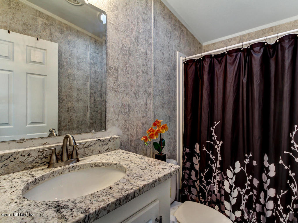 2244 Marlee Road South St. Johns, FL 32259 - Photo 24 of 38 a bathroom with a granite countertop sink and a mirror