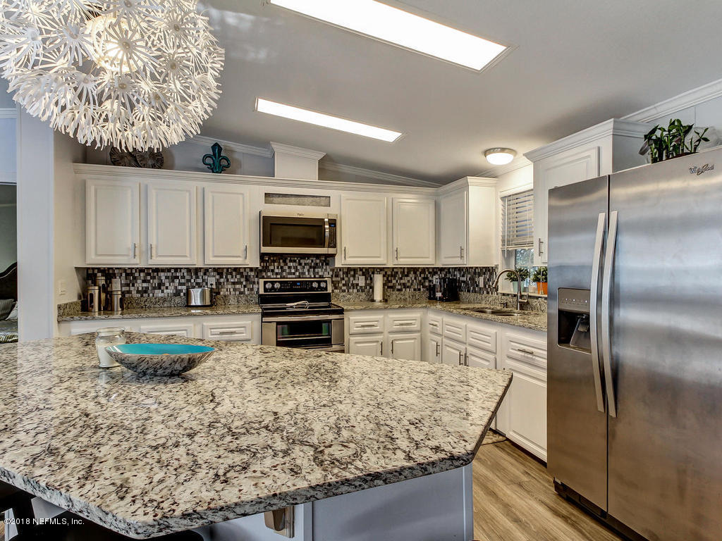2244 Marlee Road South St. Johns, FL 32259 - Photo 4 of 38 a kitchen with stainless steel appliances granite countertop a refrigerator a stove and a sink