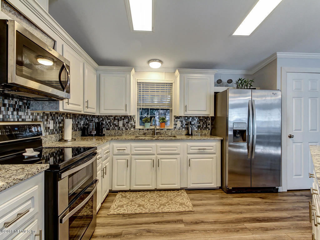 2244 Marlee Road South St. Johns, FL 32259 - Photo 6 of 38 a kitchen with stainless steel appliances granite countertop a stove a sink and a refrigerator