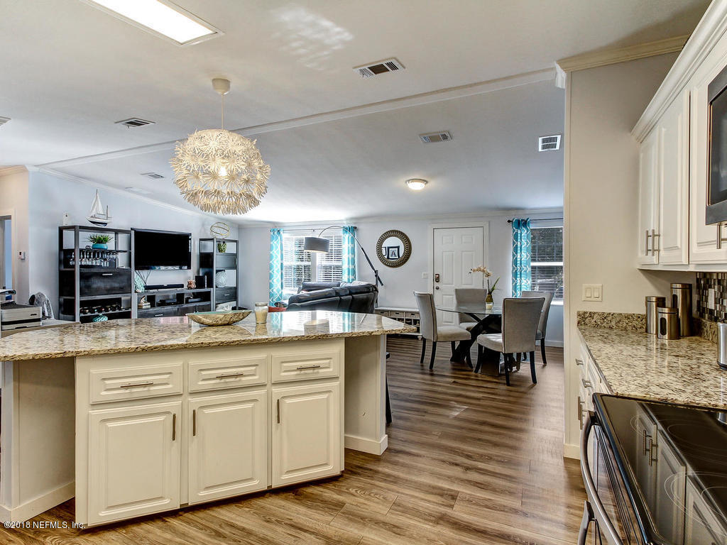 2244 Marlee Road South St. Johns, FL 32259 - Photo 8 of 38 a large kitchen with cabinets chairs and wooden floor