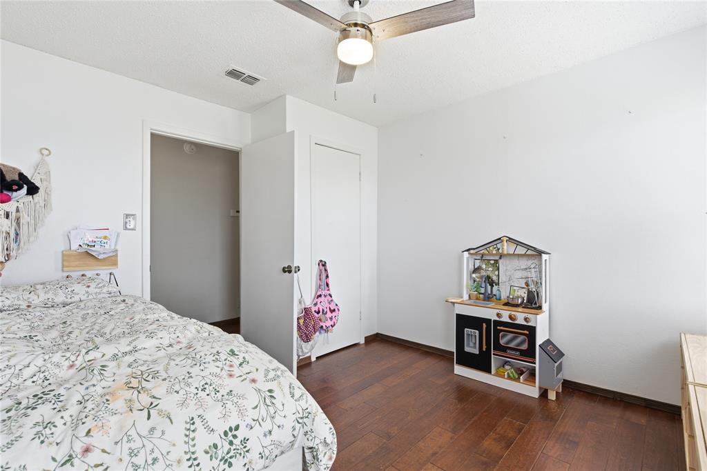 9213 Wilson Road Pilot Point, TX 76258 - Photo 23 of 38 9213 Wilson Road, Pilot Point, TX 76258 - bedroom - another view of 1st guest bedroom with a ceiling fan and dark wood-type flooring