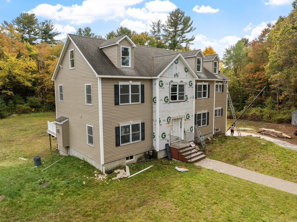12 Patten Road Westford, MA 01886 - Photo 3 of 3 a view of a white house with a yard and lawn chairs