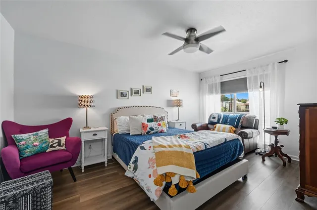 a bed room with a bed and a chair