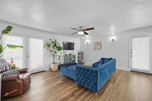 a living room with furniture and a wooden floor