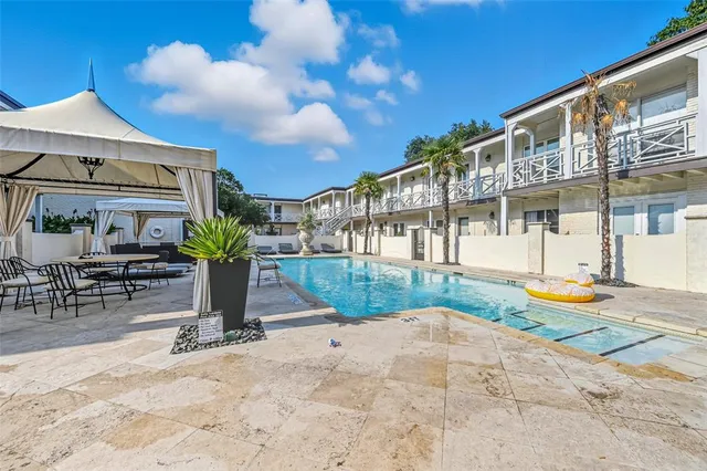 a view of a house with backyard porch and sitting area