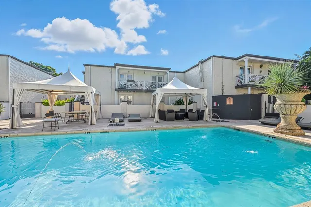 a view of a house with swimming pool and a yard