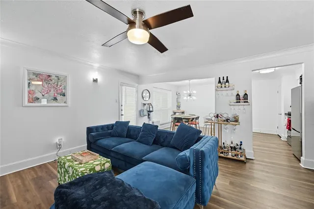 a living room with furniture and a chandelier