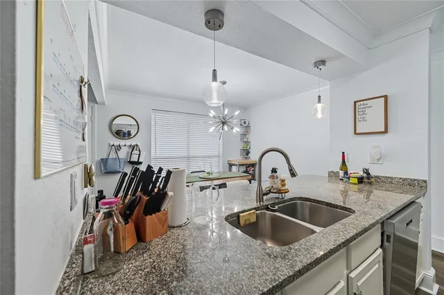 a kitchen with a sink and a stove