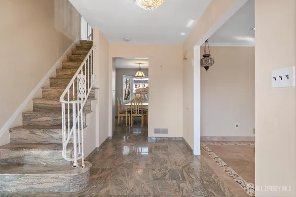 a view of a hallway with wooden floor and entryway