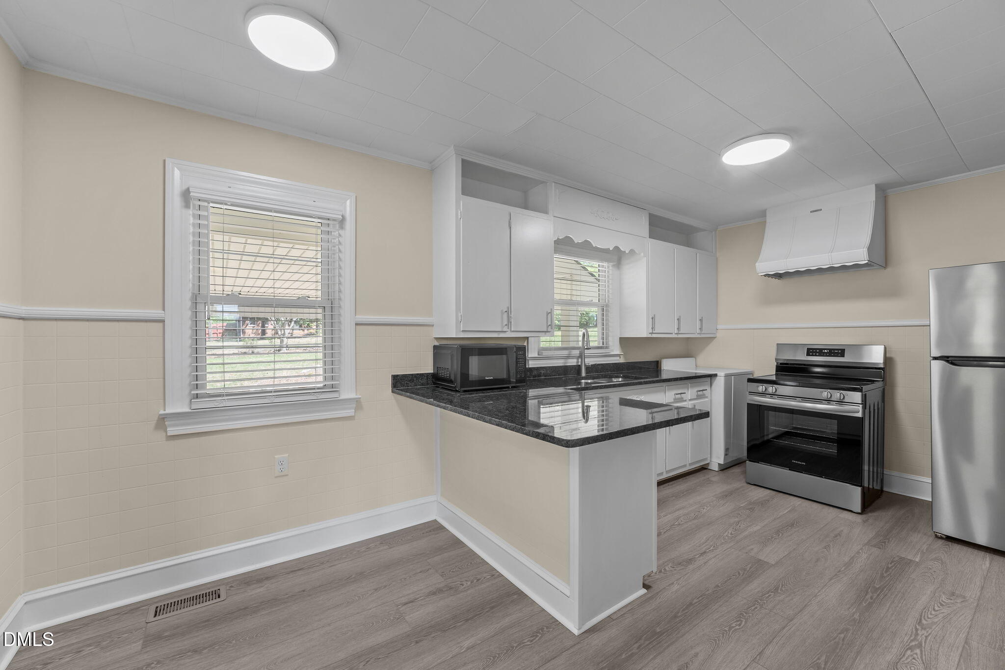1723 Power Line Road Elon, NC 27244 - Photo 10 of 22 a kitchen with stainless steel appliances granite countertop white cabinets stove a sink and dishwasher