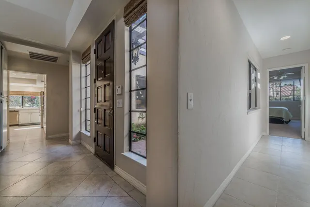 a bedroom with a bed couches and window