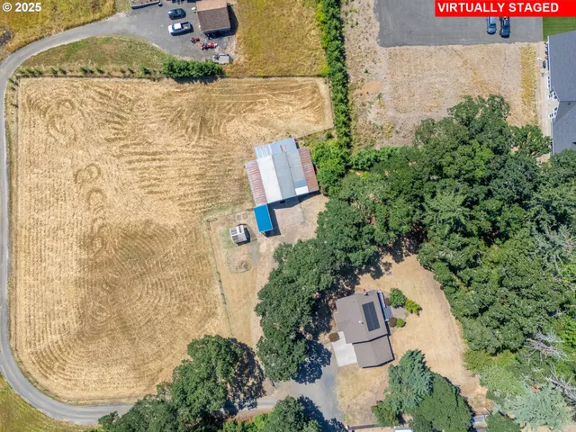an aerial view of residential house with outdoor space and trees