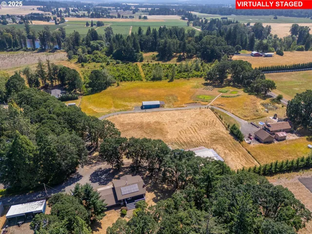 an aerial view of residential houses with outdoor space and river
