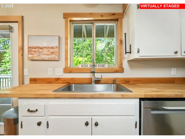a view of kitchen with kitchen island a sink a stove and a window